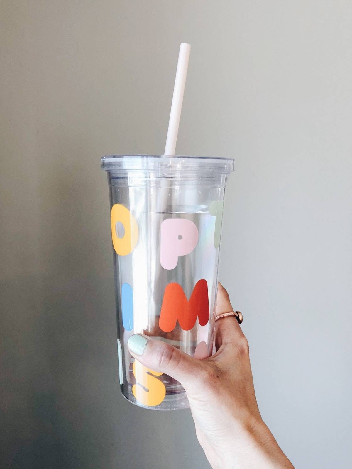 Plastic tumbler with straw.