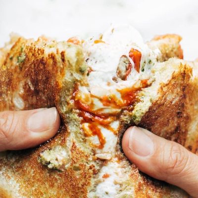 Caprese Grilled Cheese being pulled apart.