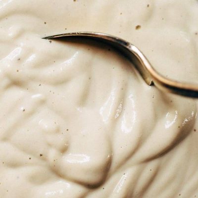 Cashew Sauce in a bowl with a spoon.
