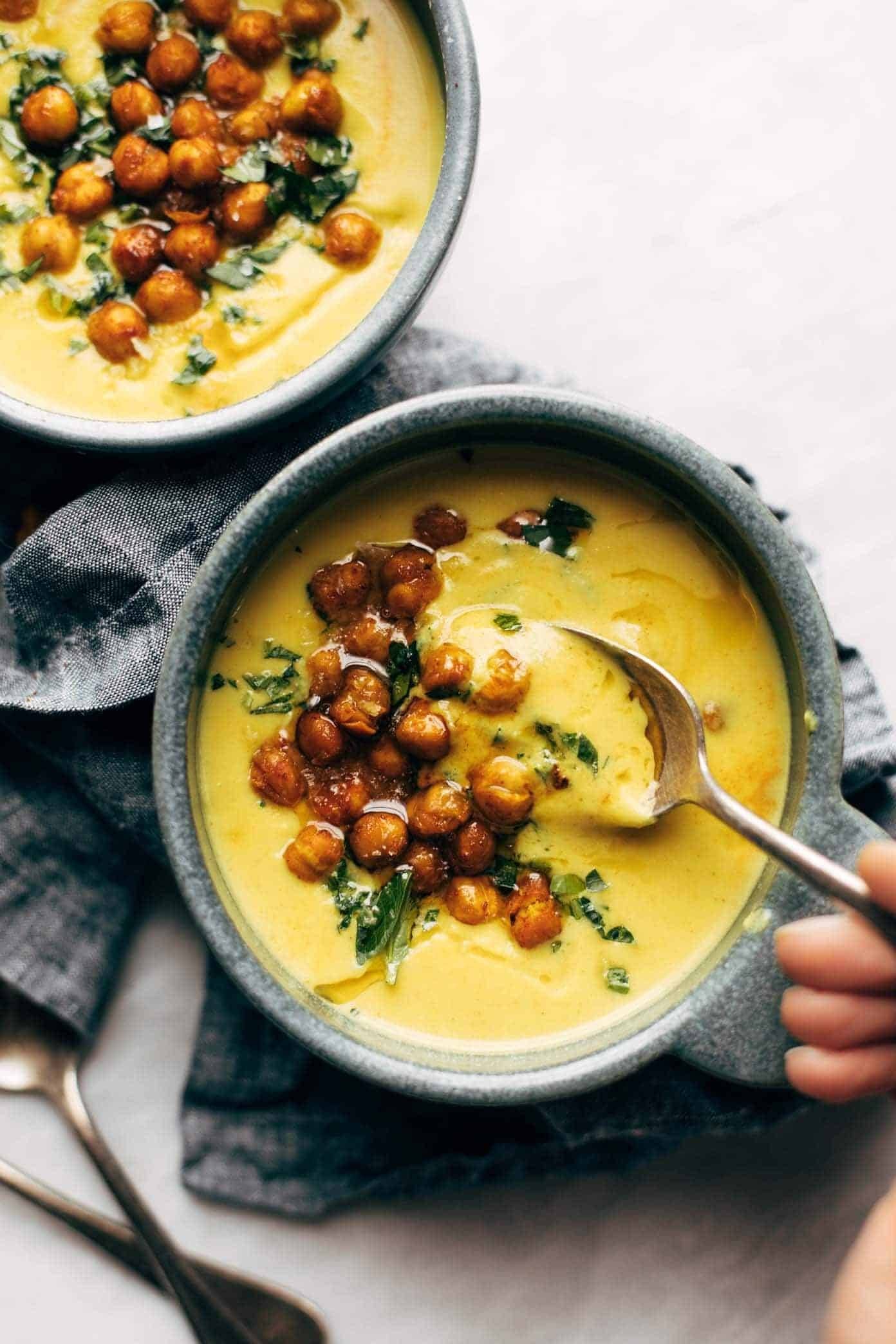Golden soup in a bowl with chickpeas.