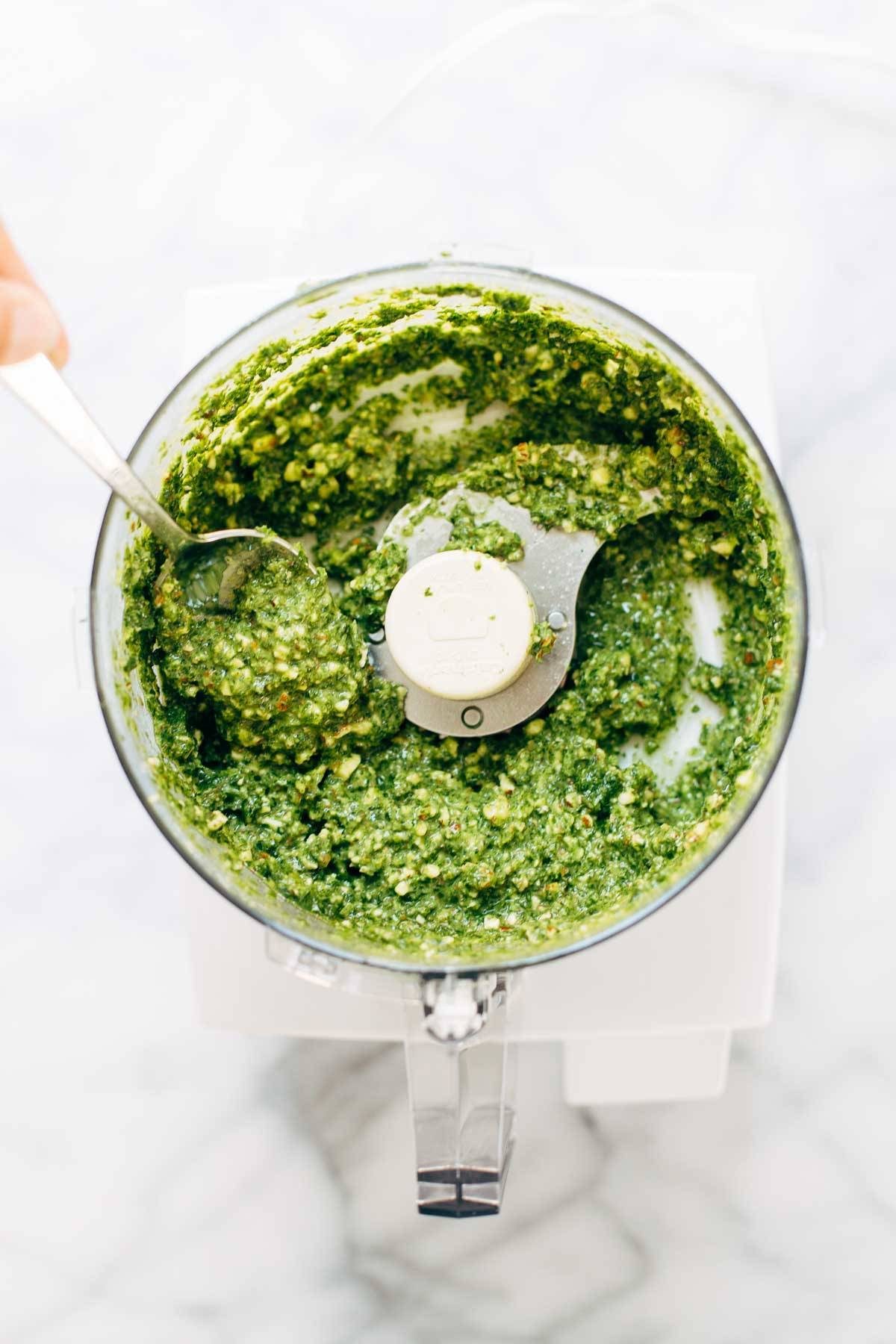 5 Minute Vegan Kale Pesto - made with almonds, olive oil, kale, garlic, salt, and lemon juice. Less than 150 calories per serving! | pinchofyum.com