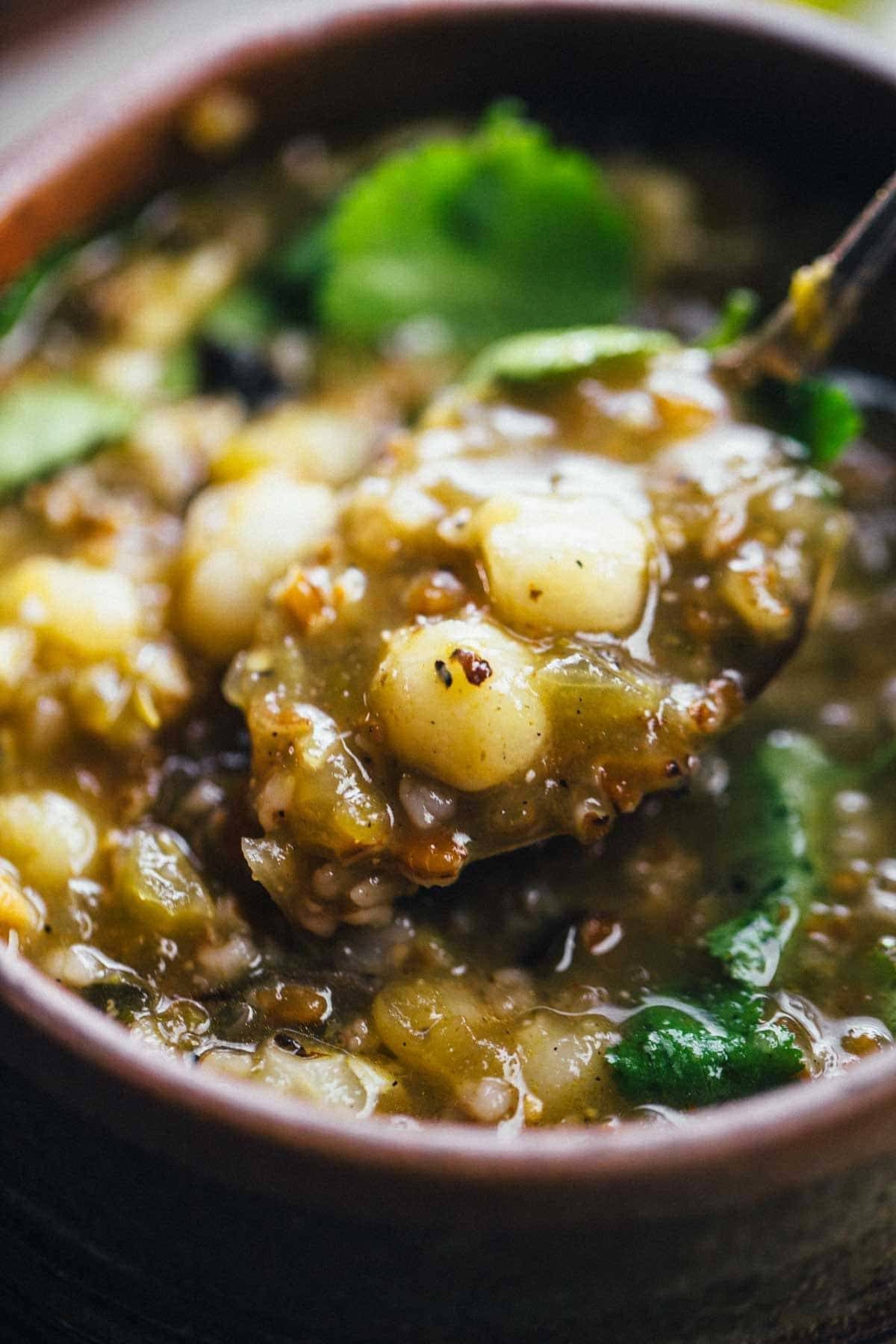 Mushroom Poblano Posole Verde on a spoon.