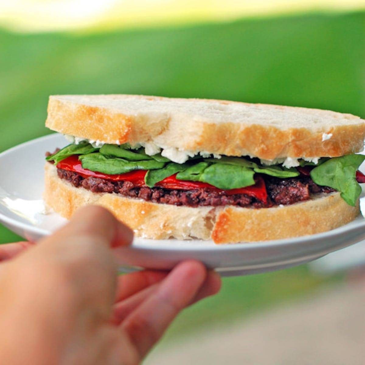 Red pepper and goat cheese panini with a layer of olive tapenade topped with roasted red pepper and soft, creamy goat cheese.