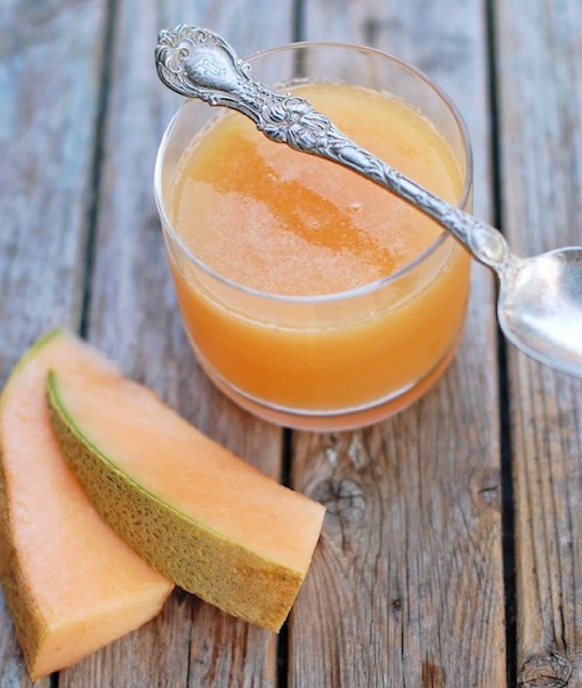 Ginger Melon Chiller in a glass with cantaloupe and a spoon.