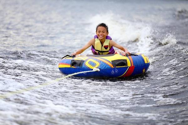 Boy tubing on the lake.