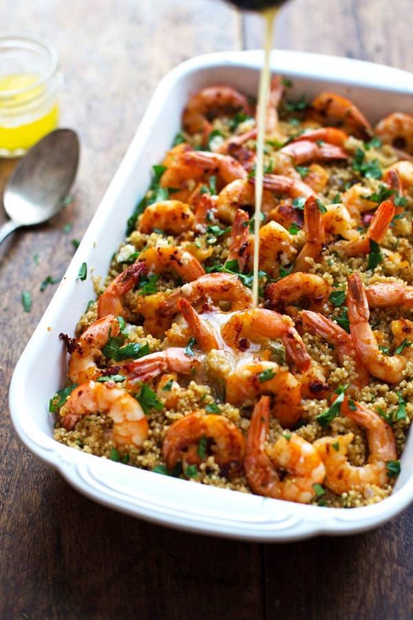Garlic Butter Shrimp and Quinoa with drizzle in a baking dish.