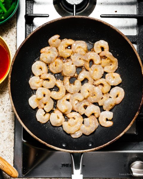 Shrimp and snap pea stir fry: a glossy, spicy, all-in-one protein and veggie dish that is just the perfect thing to make for a quick weeknight dinner. #stirfry #dinner #shrimp #snappeas