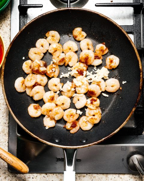 Shrimp and snap pea stir fry: a glossy, spicy, all-in-one protein and veggie dish that is just the perfect thing to make for a quick weeknight dinner. #stirfry #dinner #shrimp #snappeas