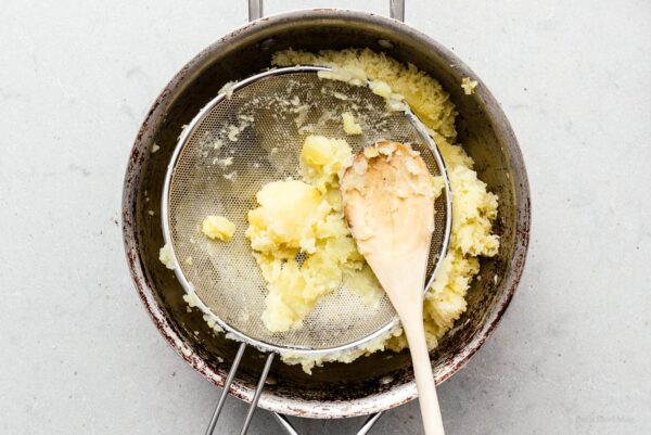 mashing potatoes with a sieve | www.iamafoodblog.com