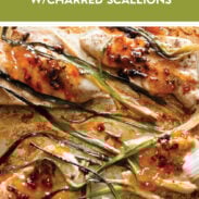 Apricot chicken on a sheet pan with charred scallions.