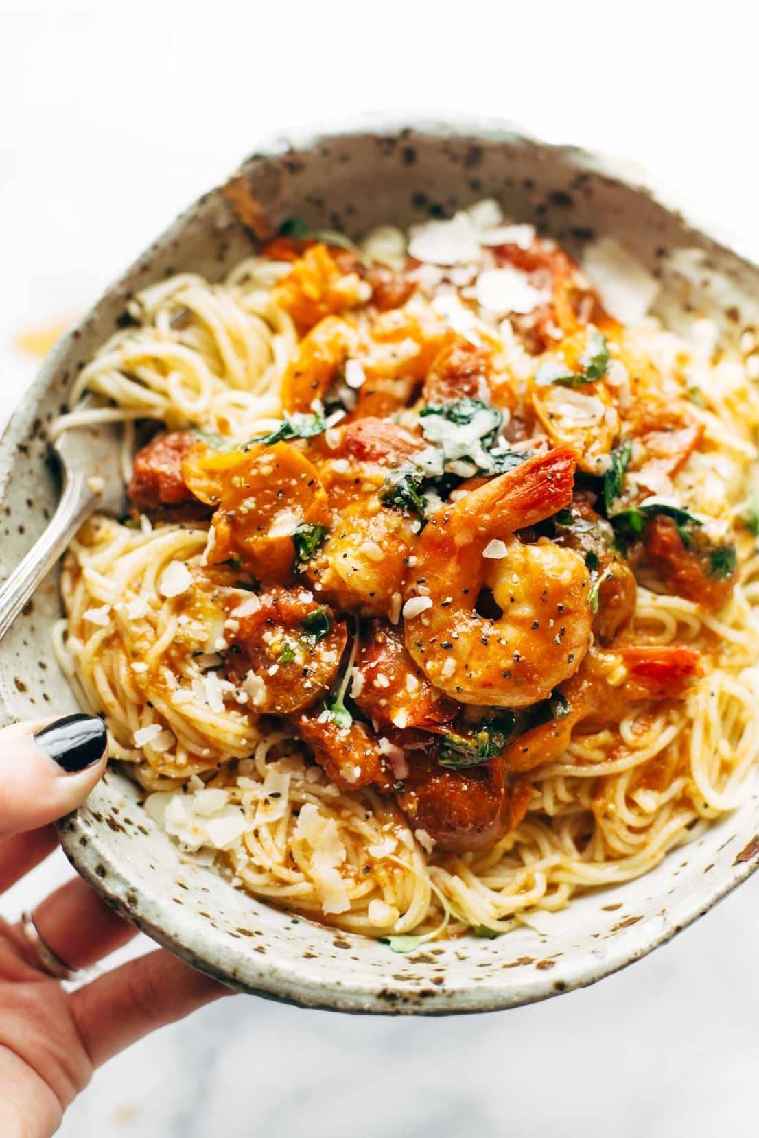 A bowl full of Garlic Butter Capellini Pomodoro with Shrimp.