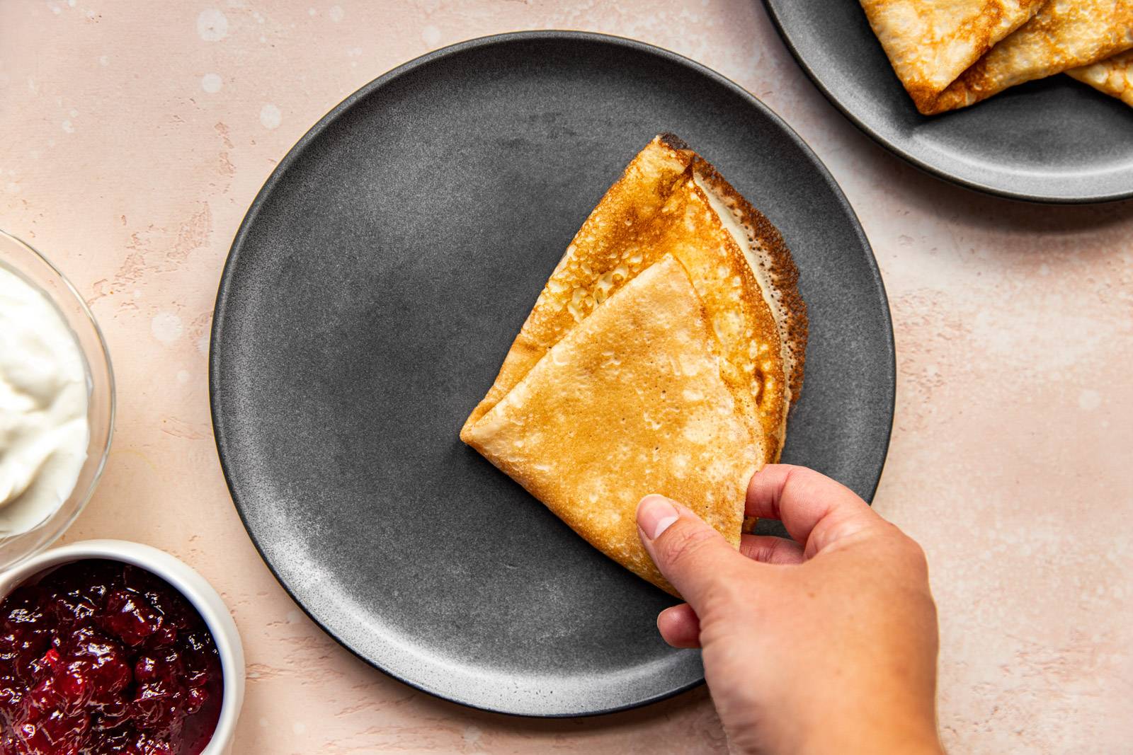 Swedish pancake folded in fourths on a plate.